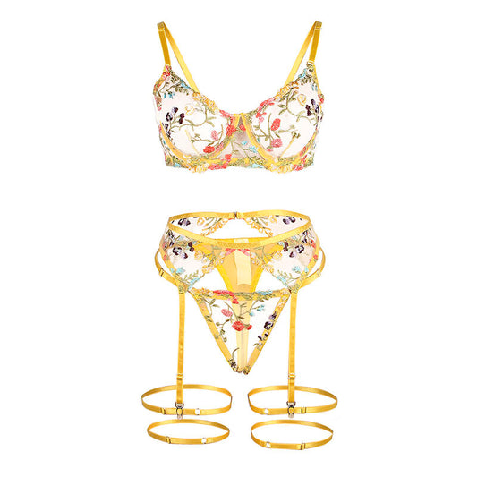 Conjunto de lingerie SUBBLIME floral amarelo, com sutiã, tanga e cinto-liga, exibindo detalhes e design.