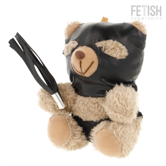 Urso de Pelúcia BDSM Luno da FETISH SUBMISSIVE com máscara preta e chicote, detalhes de arreios e correntes.
